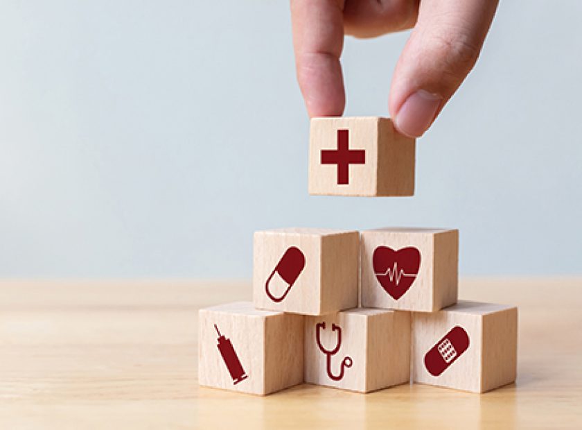 Businessman hand arranging wood block stacking with icon healthcare medical, Insurance for your health concept